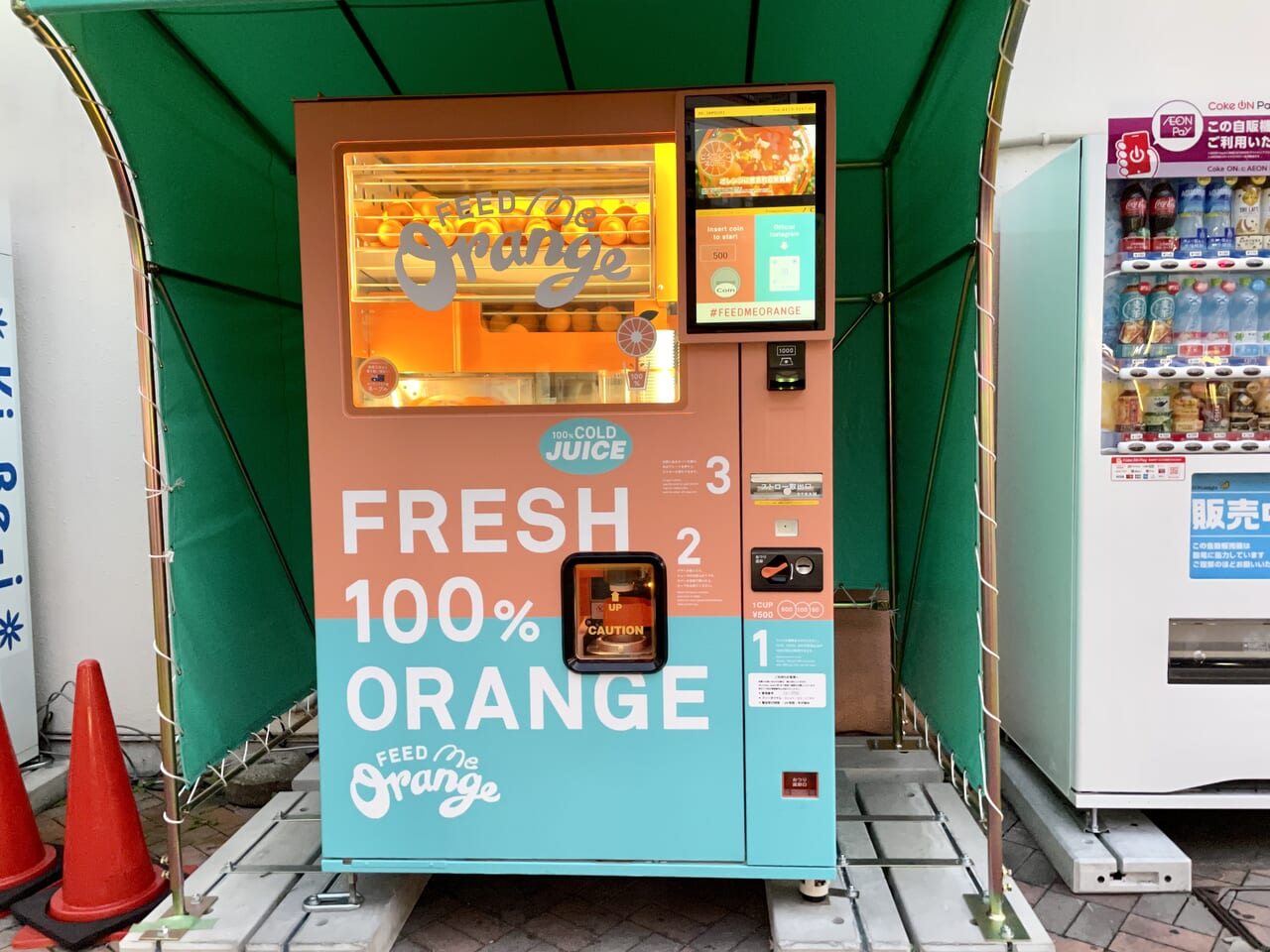 阪急池田駅前に設置されているオレンジジュースの自販機「Feed ME Orange」